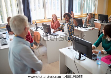 Group of smiling students asking question while attending lecture in campus