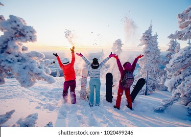 Group of snowboarders dawn with snowboards rejoice at snow. Concept life style, travel
