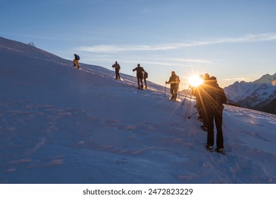 the group of snowshoes faces the climb up the snowy side of the mountain - Powered by Shutterstock