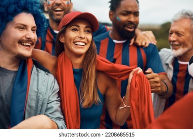 Group of soccer fans having fun while cheering for their favorite team. Focus is on young woman. - Shutterstock ID 2208685515