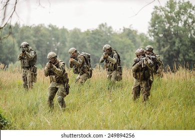 Group Of Soldiers Running Across The Field And Shoot