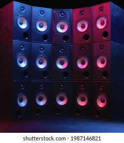 Group Of Sound Speakers In Neon Light On Black.