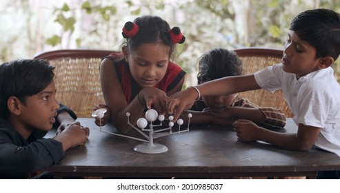 A Group Of South Asian Children Playing With Educational Toys Together