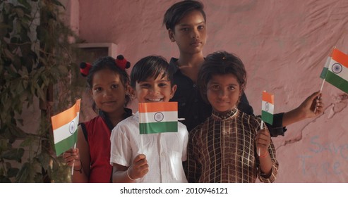 A Group Of South Asian Children Posing With Indian Flags