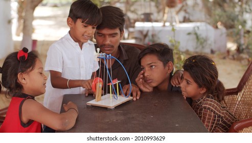 A Group Of South Asian Children And A Teacher Playing With Educational Toys