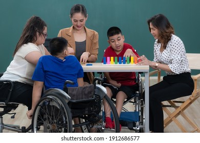 Group of special students in classroom, a down syndrome girl, two handicapped boys and cute Asian teacher playing toy and game together. - Powered by Shutterstock