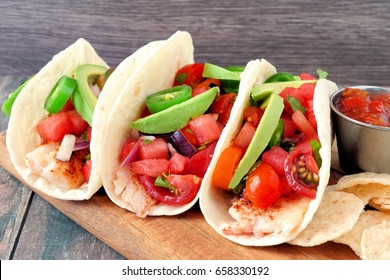 Group Of Spicy Fish Tacos With Watermelon Salsa And Avocados Close Up Side View 