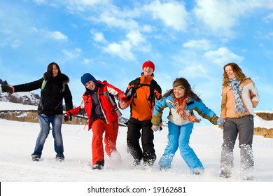 Group Of Sport Teens Different Ethnicity Jumping Winter Outdors At Mountain Tien Shan. One Boy And Four Girls.