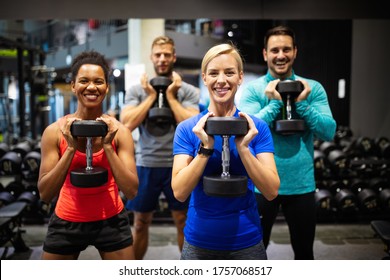 Group of sportive people in gym. Happy fit friends workout, exercise in fitness club - Powered by Shutterstock