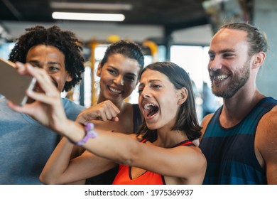 Group Of Sportive People In A Gym Having Fun, Taking Selfie.