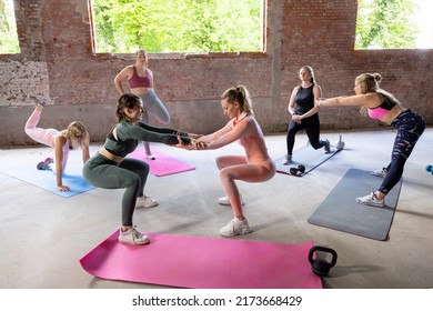 Group Of Sportive People In A Gym Training. Group Of Athletes With Diverse Body Types Stretching Before Starting A Workout Session. Yoga Class. High Quality Photo