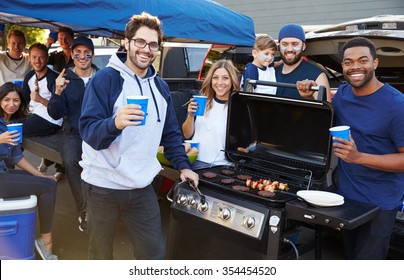 Group Of Sports Fans Tailgating In Stadium Car Park