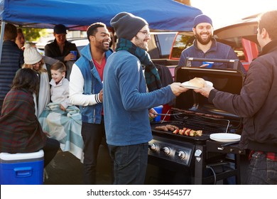 Group Of Sports Fans Tailgating In Stadium Car Park