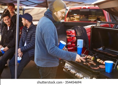 Group Of Sports Fans Tailgating In Stadium Car Park