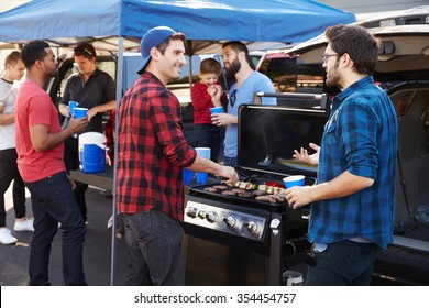 Group Of Sports Fans Tailgating In Stadium Car Park