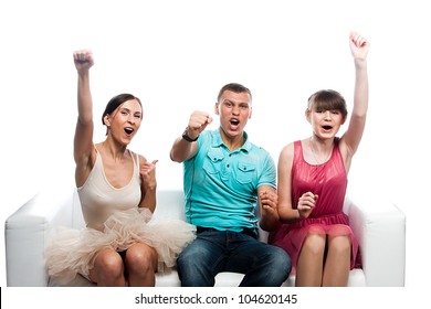 Group Of Sports Fans Watching The Competition Sitting On A White Sofa