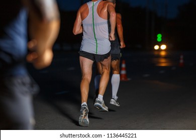 Group Of Sportsmen Running On Night Road. Healthy Lifestyle Abstract Background