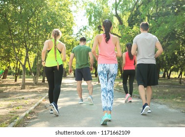Group of sporty people running outdoors - Shutterstock ID 1171662109