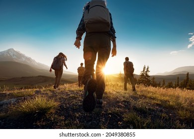Group of sporty people walks in mountains at sunset with backpacks. Altai mountains, Siberia, Russia. - Shutterstock ID 2049380855