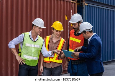 Group of staff worker standing and checking the containers box from cargo ship for export and import