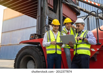 Group of staff worker standing and checking the containers box from cargo ship for export and import