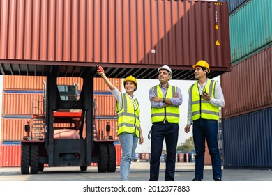Group of staff worker standing and checking the containers box from cargo ship for export and import