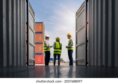 Group of staff worker standing and checking the containers box from cargo ship for export and import