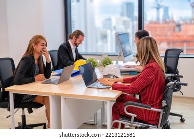 Group Of Startup Business Co-worker Working In Office With Disability Staff Sitting On Wheelchair As A Professional One Team Together