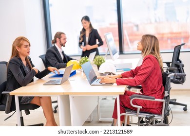 Group Of Startup Business Co-worker Working In Office With Disability Staff Sitting On Wheelchair As A Professional One Team Together