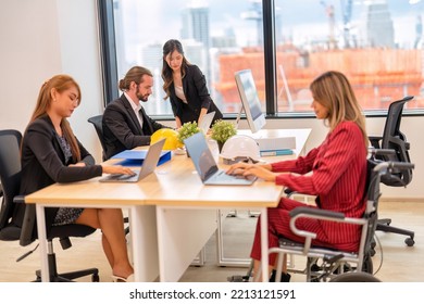 Group Of Startup Business Co-worker Working In Office With Disability Staff Sitting On Wheelchair As A Professional One Team Together