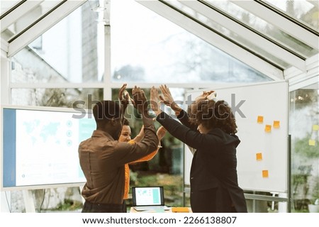 Group Startup Celebrates Success - High-Five Exchange in Office After Successful Brainstorming Session