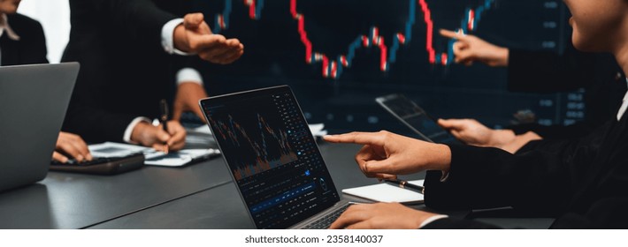 Group of stock trading investor or business people discussing and analyzing financial data graph on stock market together in meeting room. Stock trading or exchange investment planning. Trailblazing