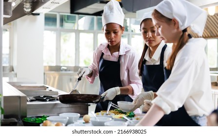 Group of student girl learning. Cooking class. culinary classroom. group of happy young woman multi - ethnic students are focusing on cooking lessons in a cooking school.  - Powered by Shutterstock