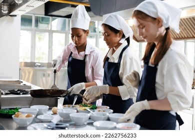 Group of student girl learning. Cooking class. culinary classroom. group of happy young woman multi - ethnic students are focusing on cooking lessons in a cooking school.  - Shutterstock ID 2262756233
