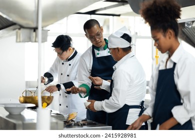 Group of student learning. Cooking class. culinary classroom. group of happy mature man and young woman multi - ethnic students are focusing on cooking lessons in a cooking school.  - Powered by Shutterstock