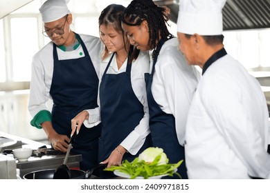 Group of student teen girl learning. Cooking class. culinary classroom. group of happy young woman multi - ethnic students are focusing on cooking lessons in a cooking school.  - Powered by Shutterstock