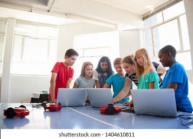 Group Of Students In After School Computer Coding Class Learning To Program Robot Vehicle