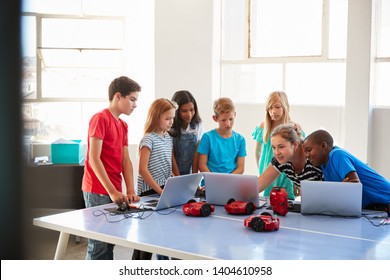 Group Of Students In After School Computer Coding Class Learning To Program Robot Vehicle