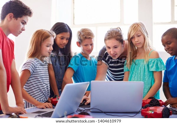 Group Of Students In After School\
Computer Coding Class Learning To Program Robot\
Vehicle