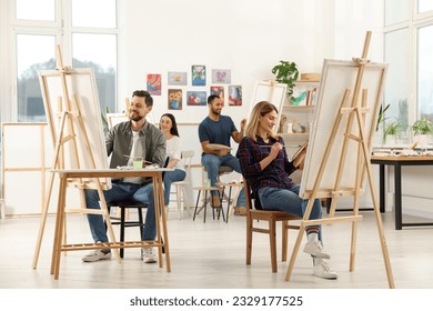 Group of students attending painting class in studio. Creative hobby - Powered by Shutterstock