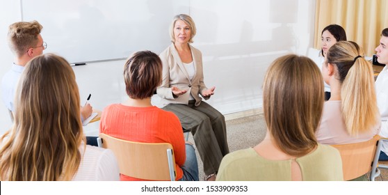 Group of students attentively listening to lecture of female teacher in classroom

 - Powered by Shutterstock