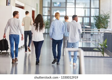 Group Of Students In College Walk In University Hallway