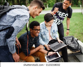 A Group Of Students From Different Countries Communicate After Classes On The Street In The Campus. The Photo Illustrates Student Life, Education At University Or College.