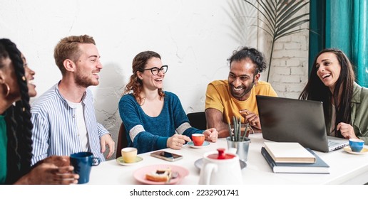 Group of students from different parts of the world having a brunch and studying in a cafeteria, young people having fun during a break in the morning - Powered by Shutterstock