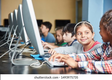 Group Of Students Doing E-learning On The PC In Elementary School In Computer Science Course