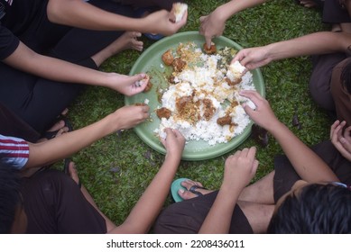 A Group Of Students Eating Together In One Big Tray With Joy And Enthusiasm