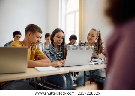 Group of students e-learning on a computer in the classroom at high school. 