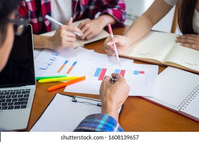 A group of students are learning and studying statistical data in mathematics in the university classroom.