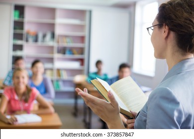 Group Of Students Listening To The Teacher In The Classroom At School