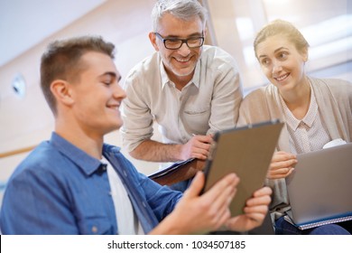 Group Of Students In Lounge Room With Teacher